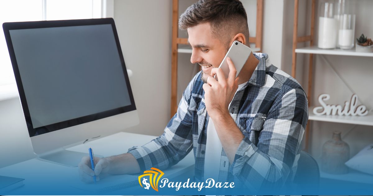 A man sitting in front of a computer calling an onloine lender to get a payday loan without proof of income