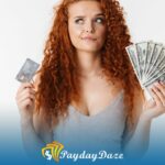 A woman holding a stack of money and a credit card after learning about the time it takes for a direct consolidation loan to pay off the old loans